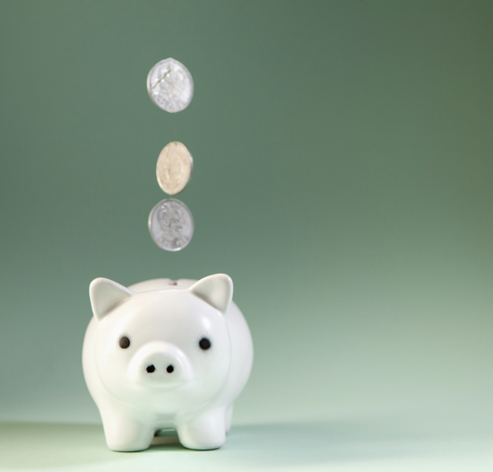 A piggy bank with coins dropping into it
